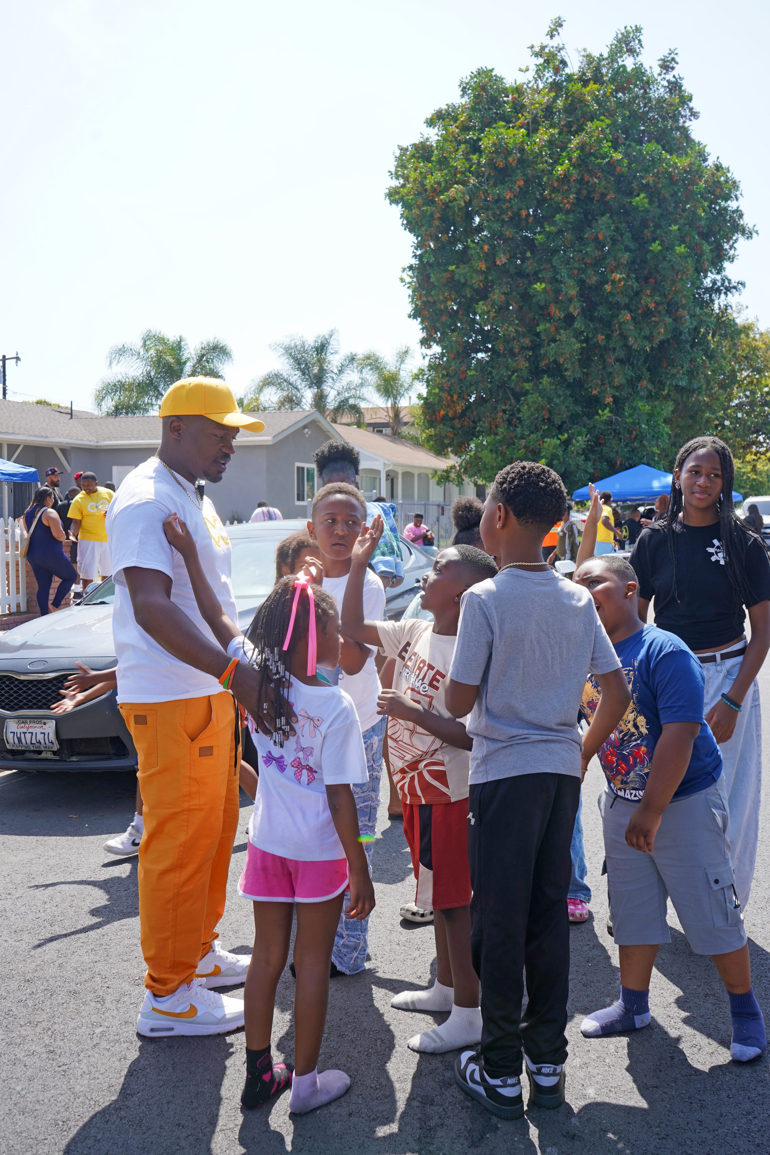 Community leader with a group of children at the Compton field day