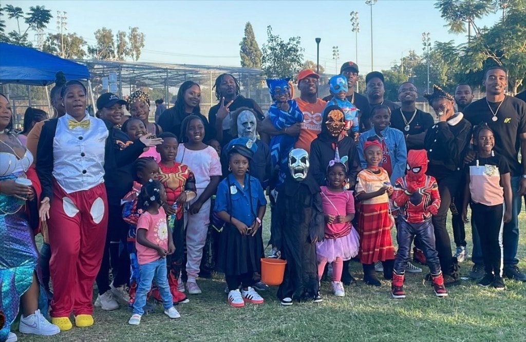 Community members and children in Halloween costumes at Bellflower