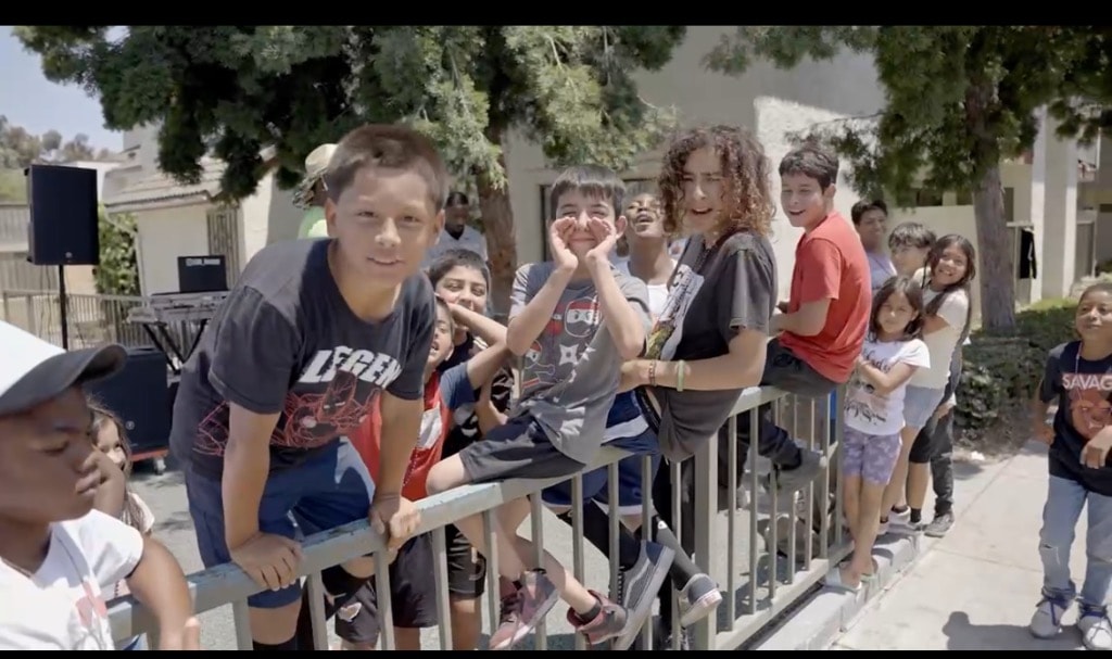 Children cheering at the inaugural Compton event